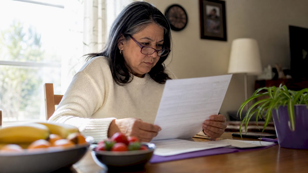 Woman reviewing diabetic insurance claim paperwork