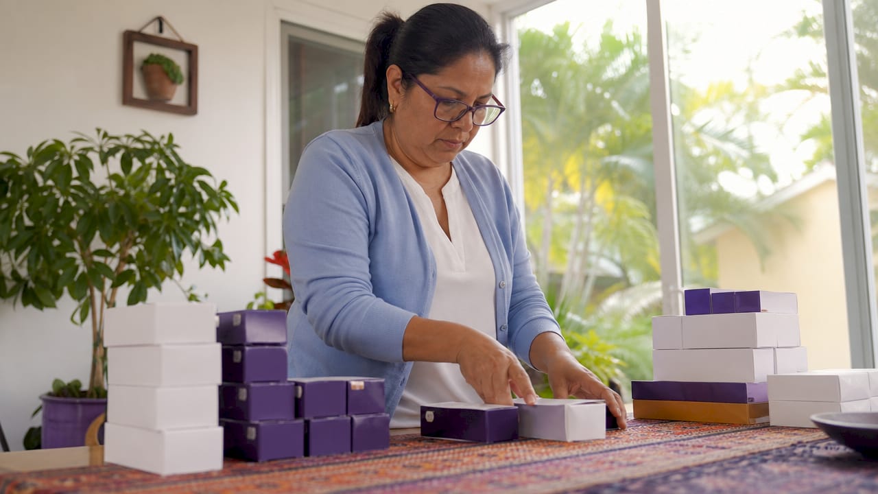 Woman sorting diabetic supplies at kitchen table