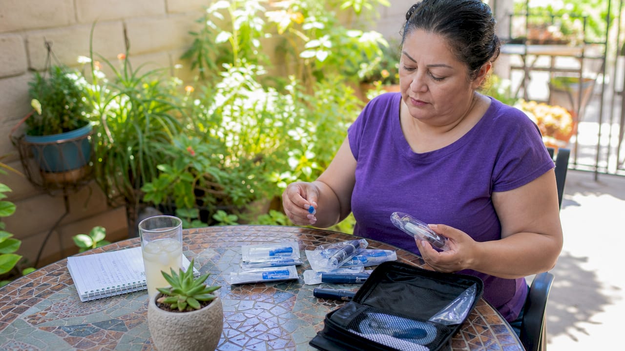 Woman organizing diabetic supplies on table