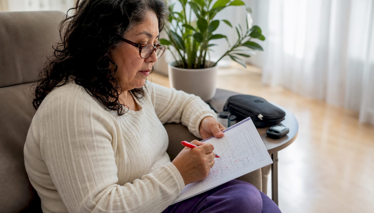 Woman reviewing diabetes supply checklist at table