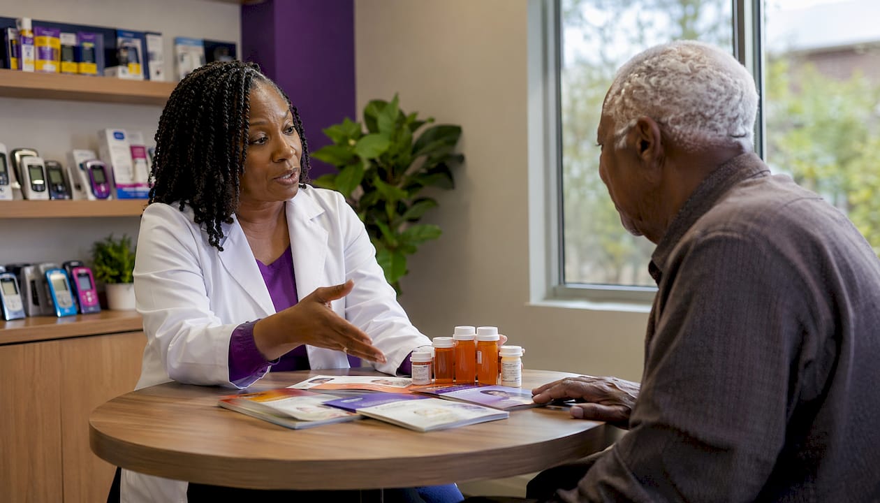 Pharmacist counseling diabetic patient in pharmacy