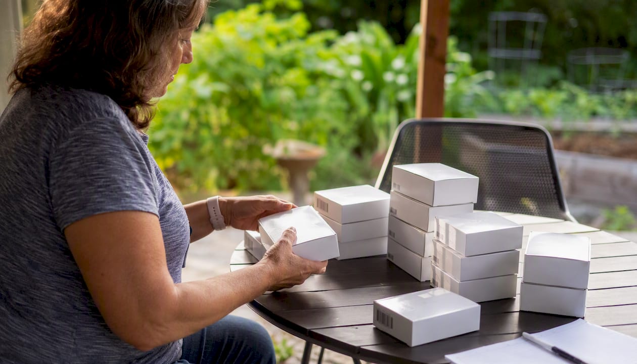 Hands organizing sealed diabetic supply boxes