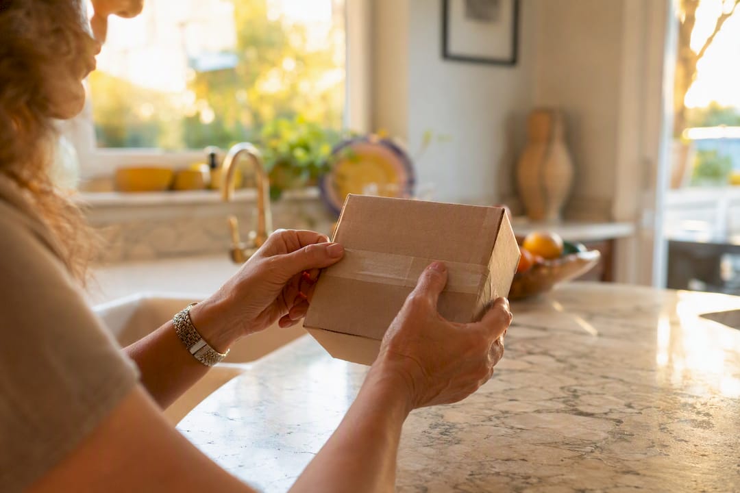 Hands inspecting sealed diabetic supply box