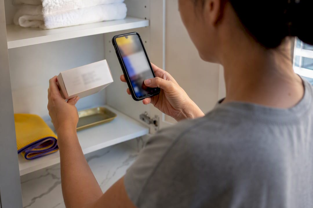 Person photographing a supply expiration date