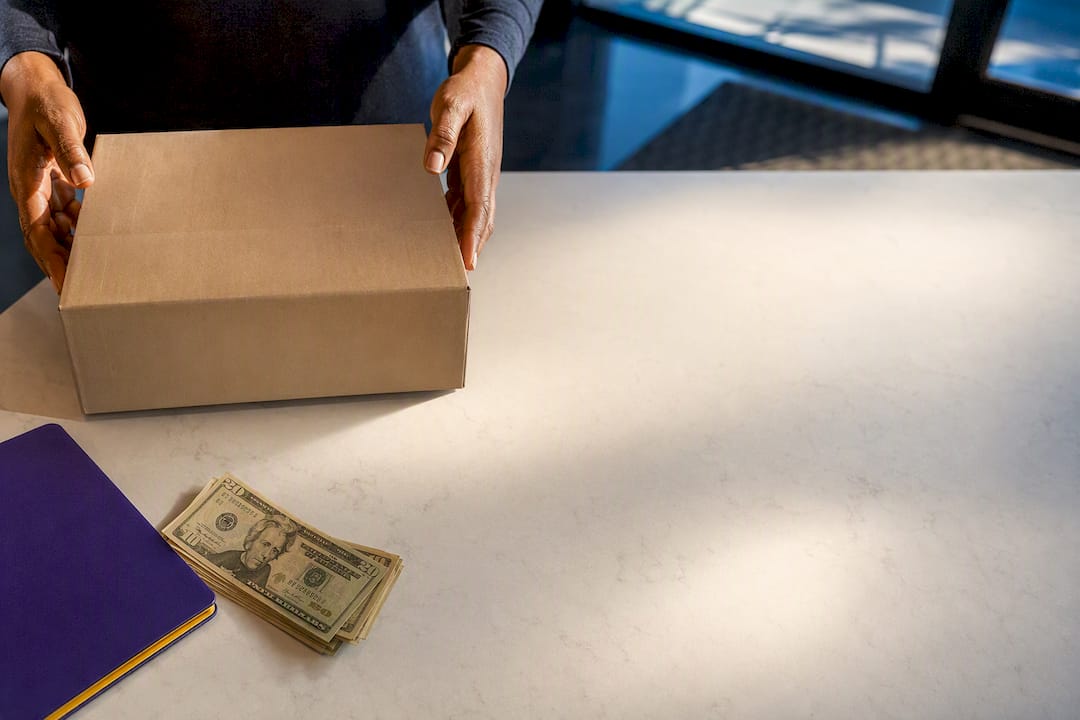 Anonymous supply carton beside cash