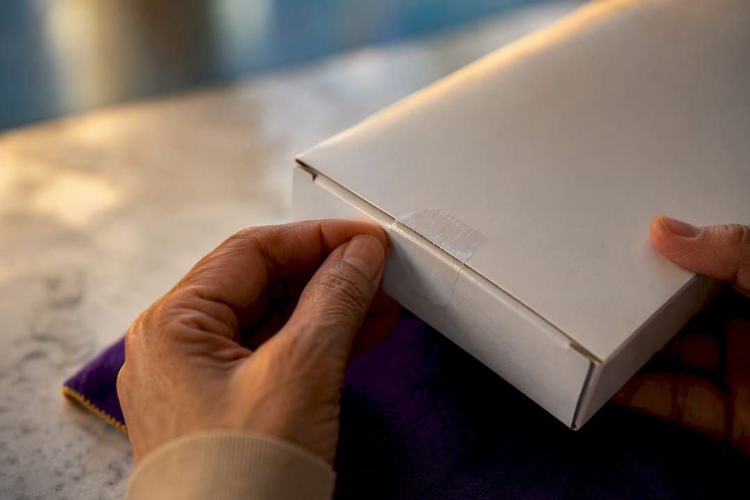 Hands inspecting sealed medical supply carton