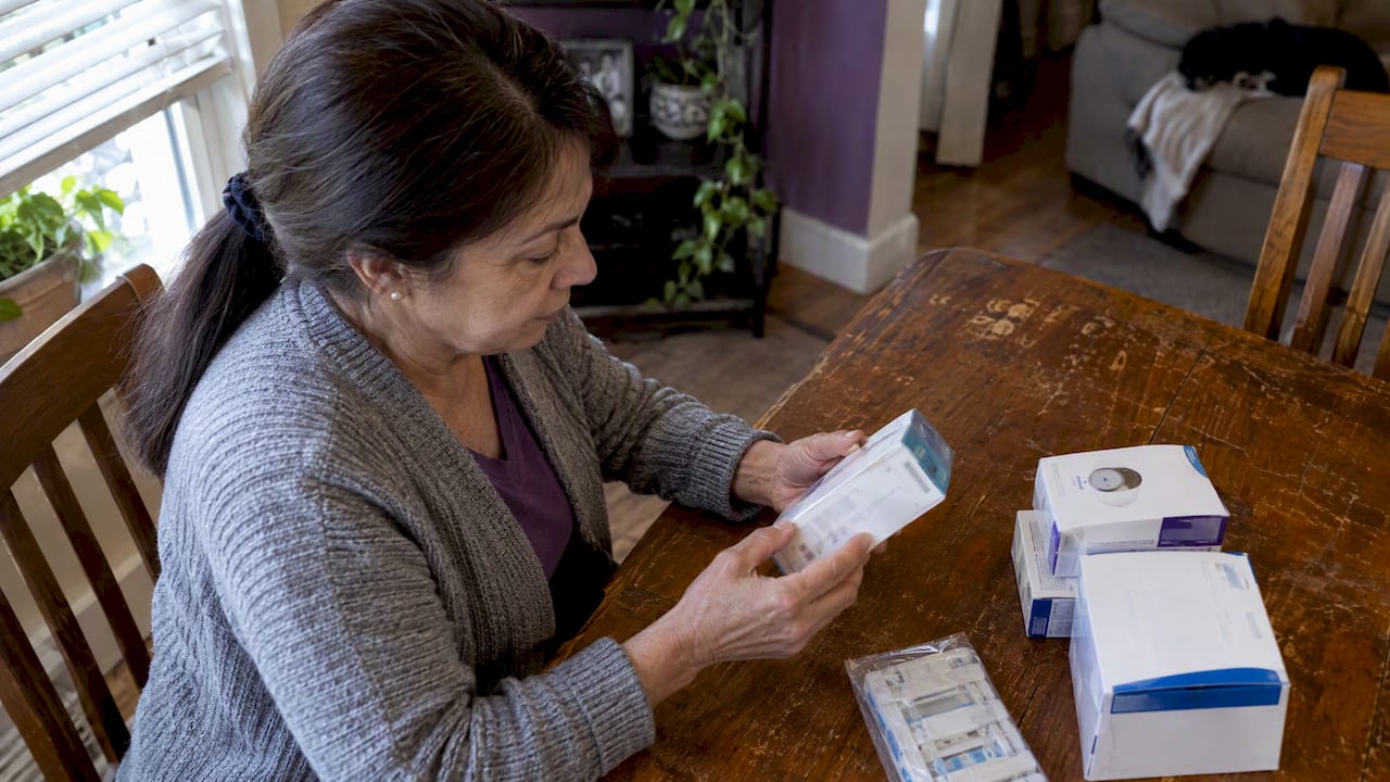Person checking dates on sealed supply boxes